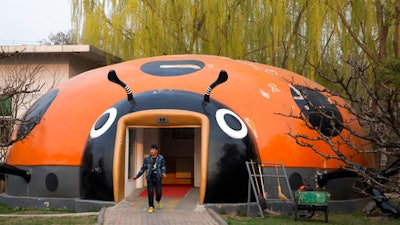 In this photo taken Wednesday, March 29, 2017, a man walks out from a ladybird shaped public toilet in Beijing, China. Launched two years ago, a 'toilet revolution' campaign calls for at least 34,000 new public bathrooms to be constructed in Beijing and 23,000 renovated by the end of this year. Authorities are also encouraging the installation of Western-style sit-down commodes rather than the more common squat toilets. Around 25 billion yuan ($3.6 billion) has already been spent on the program, according to the National Tourism Administration.