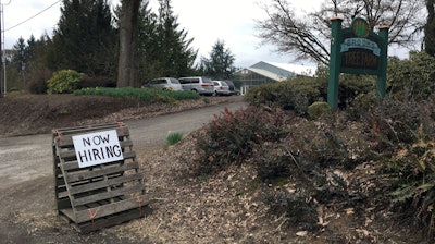 This March 2, 2017, photo shows a sign saying 'Now Hiring' in front of Brooks Tree Farm near Salem, Ore. Farmers, nursery and winery owners and others who depend on immigrant labor are predicting a catastrophe as federal immigration agents focus on stepping up arrests of people who are in America illegally.