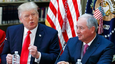Blackstone Group CEO Stephen Schwarzman listens at right, as President Donald Trump speaks during a meeting with business leaders in the State Department Library of the Eisenhower Executive Office Building on the White House complex in Washington, Tuesday, April 11, 2017.