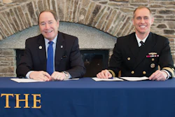 URI President David M. Dooley, left and Capt. Michael R. Coughlin, commanding officer at the Newport Naval Undersea Warfare Center, are all smiles after signing the partnership agreement.