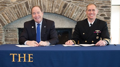 URI President David M. Dooley, left and Capt. Michael R. Coughlin, commanding officer at the Newport Naval Undersea Warfare Center, are all smiles after signing the partnership agreement.