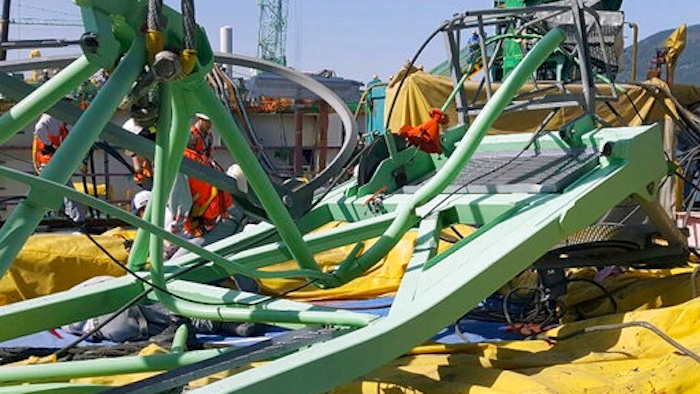 A part of a collapsed crane is seen fallen on the ground at Samsung Heavy Industries' shipyard on Geoje Island, South Korea, Monday, May 1, 2017. Samsung Heavy Industries say a crane has collapsed at its shipyard in South Korea, killing several workers and injuring many more.