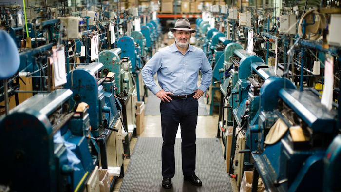 Don Rongione, President and Chief Operating Officer of Bollman Hat Company poses for a photograph with knitting machine used in the manufacturing of Kangol hats the Bollman Hat Company in Adamstown, Pa., Monday, May 1, 2017. When the famous hat brand moved into the Pennsylvania factory last year from China, executives with the Bollman Hat Co. billed it as an effort to create U.S. manufacturing jobs. “It has been certainly a bigger challenge than what we could've ever dreamed,” said Rongione.