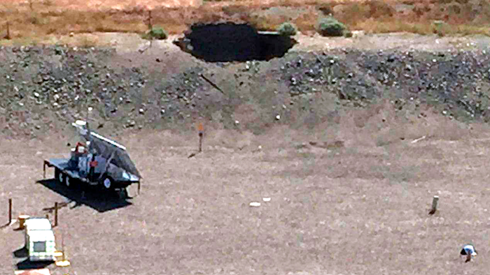 This image provided by the U.S. Department of Energy shows a 20-foot by 20-foot hole in the roof of a storage tunnel at the Hanford Nuclear Reservation near Richland, Wash., Tuesday, May 9, 2017. An emergency was declared Tuesday after the partial collapse of the tunnel that contains rail cars full of radioactive waste.