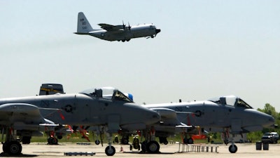 FILE - In this May 13, 2004 file photo, A-10's from the 111th Fighter Wing are seen in the foreground as a U.S. Navy C-130 takes off from N.A.S. J.R.B. Willow Grove in Willow Grove Pa. The Warthog is sitting pretty. Once on the brink of forced retirement, the A-10 attack plane with the ungainly shape and odd nickname has been given new life, spared by Air Force leaders who have reversed the Obama administration’s view of the plane as an unaffordable extra in what had been a time of tight budgets.