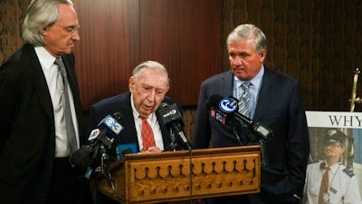 Attorneys Thomas Kline, left, Richard Sprague and Robert Mongeluzzi take part in a news conference while standing next to a photo of train engineer Brandon Bostian in Philadelphia, Thursday, May 11, 2017. A Philadelphia judge has ordered prosecutors to criminally charge the speeding Amtrak engineer involved in a 2015 derailment that killed eight people and injured about 200.