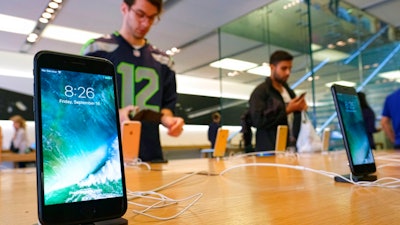 In this Sept. 16, 2016 file photo, The Apple iPhone 7 is displayed at the Apple Store at the Grove in Los Angeles. Mobile chip maker Qualcomm has filed a breach of contract complaint against Apple’s iPhone and iPad manufacturers, the latest in an ongoing dispute.