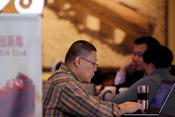In this Feb. 16, 2015 file photo, a man surfs Internet on his laptop computer at a Starbuck cafe in Beijing. Security researcher say China's fondness for pirated software left it especially vulnerable to the latest global cyberattack. Beijing has tolerated rampant use of unlicensed software copies despite repeated promises to crack down and warnings by industry groups that China is leaving itself open to being hurt by malicious code.