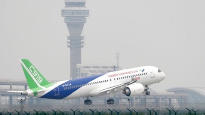 A Chinese-made C919 passenger jet takes off on its first flight at Pudong International Airport in Shanghai, Friday, May 5, 2017. The first large Chinese-made passenger jetliner took off on its maiden test flight, a symbolic milestone in China's long-term goal to break into the Western-dominated aircraft market.