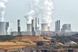 In this April 3, 2014 file photo giant machines dig for brown coal at the open-cast mining Garzweiler in front of a smoking power plant near the city of Grevenbroich in western Germany. Despite uncertainties about whether the United States will remain committed to the Paris climate accord under President Donald Trump, diplomats convened talks in Bonn, Germany, Monday, May 8, 2017 on implementing the details of the global deal to combat global warming.