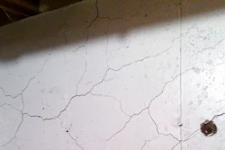 In this April 11, 2017 photo, numerous cracks run through a basement wall of Tim Heim's home in Willington, Conn. Home foundations in a part of the state are failing because of the presence of the mineral pyrrhotite in the concrete, and a growing number of homeowners are seeking financial relief from their town.