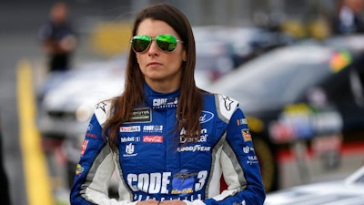 Danica Patrick stands by her car before qualifying for Sunday's NASCAR Cup series auto race at Charlotte Motor Speedway in Concord, N.C., Thursday, May 25, 2017.