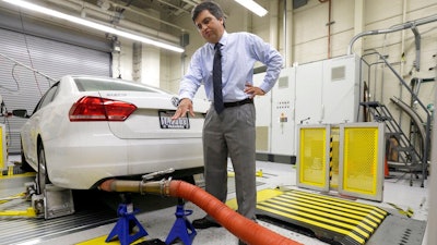 In this Sept. 30, 2015, file photo, a 2013 Volkswagen Passat with a diesel engine is evaluated at the emissions test lab in El Monte, Calif. Real world pollution from diesel trucks, buses and cars globally is more than 50 percent higher than what government lab testing says it should be. And that translates to an extra 38,000 deaths worldwide from soot and smog, a new study say.