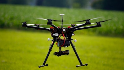 In this June 11, 2015, file photo, a hexacopter drone is flown during a drone demonstration in Cordova, Md. An appeals court has struck down a Federal Aviation Administration rule that required owners to register drones used for recreation.
