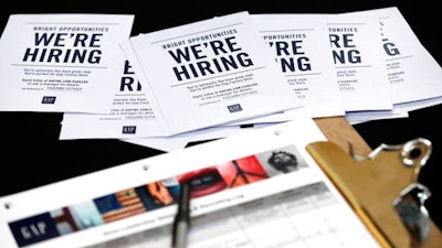 In this Tuesday, Oct. 6, 2015, file photo, job applications and information for the Gap Factory Store sit on a table during a job fair at Dolphin Mall in Miami. As the latest jobs report comes out, Friday, May 5, 2017, the five fastest-growing sectors in the 12 months prior have been: temporary help, professional and technical services, construction, education and health care.