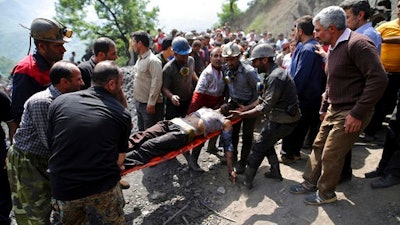 In this picture released by the Tasnim News Agency, miners and rescue personnel carry an injured mine worker after a coal mine explosion, near Azadshahr in northern Iran, Wednesday, May, 3, 2017. Iranian state media said Wednesday that a large explosion struck the coal mine, trapping dozens of miners and killing at least two. Ambulances, helicopters and other rescue vehicles raced to the scene on Wednesday in Golestan province as authorities worked to determine the scale of the emergency.
