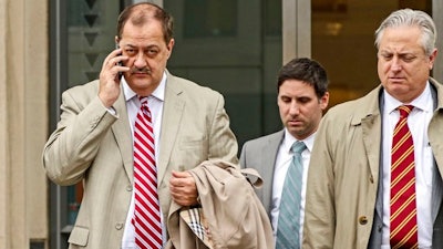 In this Tuesday, Dec. 1, 2015, file photo, former Massey Energy CEO Don Blankenship, left, makes his way out of the Robert C. Byrd U.S. Courthouse during a break in deliberations, in Charleston, W. Va. Blankenship is finishing up his one-year federal prison sentence related to the deadliest U.S. mine explosion in four decades. According to the U.S. Bureau of Prisons website, Blankenship is set to be released Wednesday, May 10, 2017, from a halfway house in Phoenix. He must serve one year of supervised release.