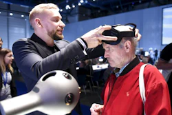 Nokia's Mikko Korhonen, left, demonstrates to Pauli Kuikka how to use the OZO Virtual Reality camera before a the general meeting of the Finnish telecommunication network company Nokia in Helsinki, Tuesday May 23, 2017. Nokia and Apple have settled their numerous legal disputes after signing an agreement to work together. Nokia, once the world's No. 1 cellphone maker and now a networks provider after selling its ailing mobile phone sector to Microsoft in 2014, described the pact as 'meaningful.'