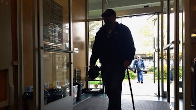 In this April 7, 2017, photo, patrons walk into the main Josephine County library branch in Grants Pass, Ore., as it opens its doors in the morning. The library system in Josephine County has been operating as a nonprofit on donations and volunteer hours since it lost public funding, but a measure on the May 16, 2017, ballot could restore limited tax dollars by creating a special library tax district.