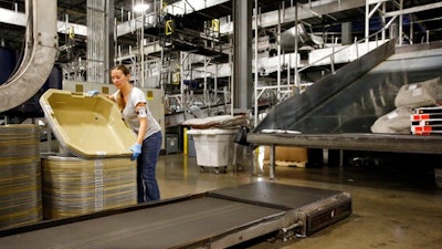 In this Nov. 20, 2015, photo, a UPS employee works inside the company's Worldport hub in Louisville, Ky. On Friday, May 5, 2017, the U.S. government issues the April jobs report.