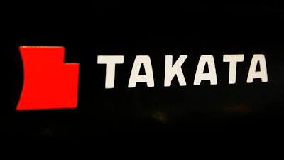 This July 6, 2016, file photo, shows the logo of Takata Corp. at an auto supply shop in Tokyo. On Thursday, May 18, 2017, Toyota, Subaru, Mazda and BMW reached a proposed settlement that would compensate owners of 15.8 million vehicles for economic losses stemming from the massive recall of Takata air bags.
