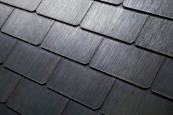 This photo provided by Tesla shows a detail of Tesla's new textured solar roof tiles. As of Wednesday, May 10, 2017, customers worldwide could order a solar roof on Tesla's website. The glass tiles are designed to look like a traditional roof, with options that replicate slate or terracotta tiles. The solar tiles contain photovoltaic cells that are invisible from the street. Installations will begin in June in the U.S., starting with California. Installations outside the U.S. will begin in 2018, the company said.