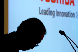 In this April 11, 2017 file photo, Toshiba Corp.'s President Satoshi Tsunakawa bows during a press conference at the company's headquarters in Tokyo. Money-losing Japanese electronics company Toshiba is sparring with its U.S. joint venture partner Western Digital over the planned sale of Toshiba's computer-chip business. Toshiba warned Western Digital to stop interfering, according to letters seen Tuesday, May 9, by The Associated Press. The letters from the company's lawyers, dated May 3, accused Western Digital of 'improper' interference.
