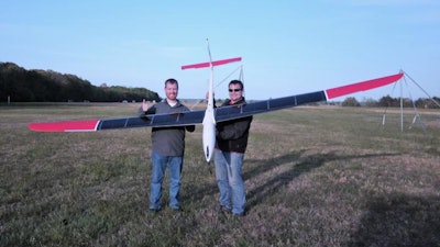 Holding the photovoltaic UAV based on the the SBXC sailplane, are members of the 'Solar-Soaring' research flight crew (l-r) Dan Edwards and Trent Young (not shown: Chris Bovais, Sam Carter, Matthew Kelly, and Dave Scheiman).