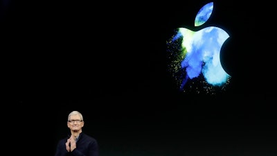 n this Oct. 27, 2016, file photo, Apple CEO Tim Cook speaks during an announcement of new products in Cupertino, Calif. Apple will invest $1 billion to help create more U.S. manufacturing jobs and counter recurring criticism about its reliance on overseas factories to assemble most of its iPhones and other devices.