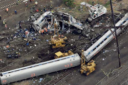 In this file photo, emergency personnel work near the wreckage of a New York City-bound Amtrak passenger train following a derailment that killed eight people and injured about 200 others in Philadelphia.