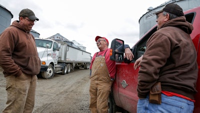 Blake Hurst, a corn and soybean farmer and president of the Missouri Farm Bureau, center, jokes with his brothers Brooks Hurst, left, and Kevin Hurst, right, on his farm in Westboro, MO.