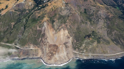 In this aerial photo taken Monday, May 22, 2017 provided by John Madonna showing a massive landslide along California's coastal Highway 1 that has buried the road under a 40-foot layer of rock and dirt. A swath of the hillside gave way in an area called Mud Creek on Saturday, May 20, covering about one-third of a mile, half a kilometer, of road and changing the Big Sur coastline.