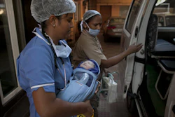 In this Nov. 3, 2015 photo, a newborn baby is transferred to an ambulance at the Akanksha Clinic, one of the most organized clinics in the surrogacy business, in Anand, India.
