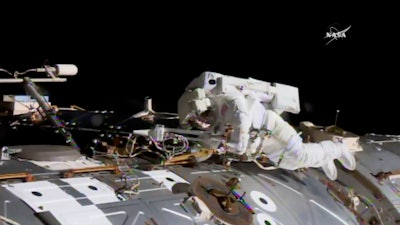 In this NASA provided frame from video, NASA astronaut Jack Fischer works to install antennas at the International Space Station while astronaut Peggy Whitson, not pictured, works on repairs Tuesday, May 23, 2017.