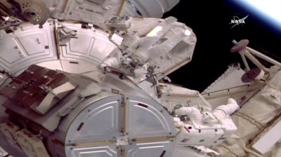 This still image provided by NASA shows astronauts Jack Fischer, left, and Peggy Whitson on a spacewalk outside the International Space Station on Friday, May 12, 2017. An equipment water leak has shortened the spacewalk. During preparations earlier in the morning, water leaked from the connection point between an umbilical hose and Fischer's suit. The hose is one of two that provide water, oxygen, power, cooling and communications for astronauts before they float outside.