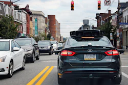 In this Wednesday, Sept. 14, 2016, file photo, a self-driving Uber car stops at a red light on Liberty Avenue through the Bloomfield neighborhood of Pittsburgh. In just a few years, well-mannered self-driving robotaxis will share the roads with reckless, law-breaking human drivers. The prospect is causing migraines for the people developing the robocars and is slowing their development. But experts say eventually the cars will coexist with human drivers on real roads.