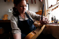 Sonja St. John applies varnish on a violin at her workshop in Neenah, Wis., on Thursday, April 27, 2017. Her brother, Jon St. John, died in Iraq in 2007 while serving in the military. Among other things, Sonja has found solace in her career, making and restoring violins.