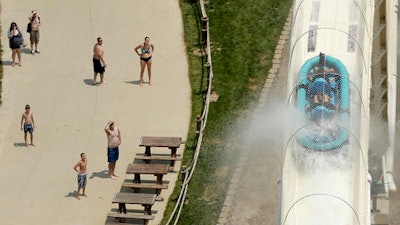 In this July 9, 2014 file photo, riders are propelled by jets of water as they go over a hump while riding a water slide called 'Verruckt' at Schlitterbahn Waterpark in Kansas City, Kan. A 12-year-old boy died Sunday, Aug. 7, 2016, on the Kansas water slide that is billed as the world's largest, according to officials. Kansas City, Kansas, police spokesman Officer Cameron Morgan said the boy died at the Schlitterbahn Waterpark, which is located about 15 miles west of downtown Kansas City, Missouri. Schlitterbahn spokeswoman Winter Prosapio said the child died on one of the park's main attractions, Verruckt, a 168-foot-tall water slide that has 264 stairs leading to the top.