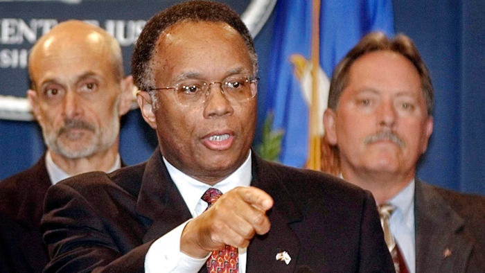In this Oct. 17, 2002 file photo Deputy Attorney General Larry Thompson, center, talks with reporters in Washington, United States. At left, Michael Chertoff, then head of the Justice Department's Criminal Division, and FBI Deputy Director Bruce Gebhardt, right, listen. Thompson the independent monitor overseeing Volkswagen's efforts to prevent a repeat of its emissions scandal says he has a 'broad mandate' to review the company's practices and that his initial impression is that VW is making a serious effort to reform.