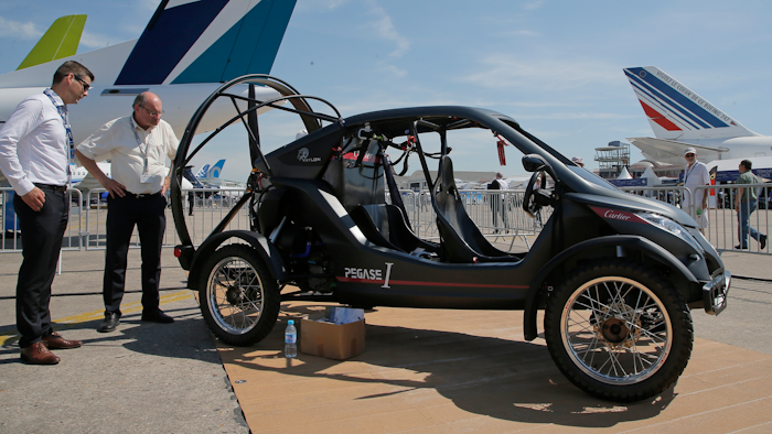 Visitors looks at the flying car Pegasus 1, built by French entrepreneur Jerome Dauffy at Paris Air Show, in Le Bourget, east of Paris, France, Tuesday, June 20, 2017 in Paris. Aviation professionals and spectators are expected at this week's Paris Air Show, coming in, in a thousands from around the world to make business deals.