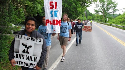 Scores of dairy farm workers and activists marching in Montpelier, Vt., on Saturday June, 17, 2017. They were marching to the main Ben & Jerry's factory in the Vermont town of Waterbury to protest what they feel are slow negotiations to reach a deal on their 'Milk with Dignity' program that would ensure fair wages and living conditions. Ben & Jerry's spokesman Sean Greenwood says the company is committed to reaching a deal with workers.