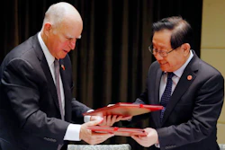 California Gov. Jerry Brown, left, exchanges memorandum of understanding with China's Science and Technology Minister Wan Gang after the Clean Technology signing ceremony at a hotel in Beijing, Tuesday, June 6, 2017.