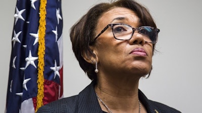 In this June 20, 2017, file photo, Flint, Mich. Mayor Karen Weaver listens to a question during a closed news conference discussing the water source recommendation made for Flint at City Hall. The state of Michigan sued Flint on Wednesday, June 28, 2017, alleging that the city council's refusal to approve a broadly backed deal to buy water long term from a Detroit-area system is endangering public health in the wake of a man-made crisis that left the supply contaminated with lead. The Department of Environmental Quality had threatened legal action if the council did not approve Weaver's recommendation or propose a reasonable alternative by Monday.