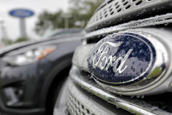 In this file photo, Ford vehicles sit on the lot at a car dealership in Florida. Ford will export vehicles from China to the U.S. for the first time starting in 2019.