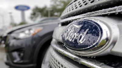 In this file photo, Ford vehicles sit on the lot at a car dealership in Florida. Ford will export vehicles from China to the U.S. for the first time starting in 2019.