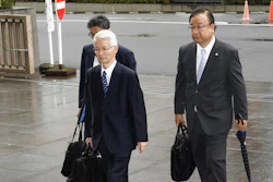 Tsunehisa Katsumata, center, former chairman of Tokyo Electric Power Co. (TEPCO), accompanied by his lawyers, arrives at Tokyo District Court for a trial in Tokyo Friday, June 30, 2017. Three former executives of TEPCO, including Katsumata, are going on trial for alleged negligence in the 2011 Fukushima nuclear disaster. The trial is the first to consider whether the utility can be held criminally responsible.