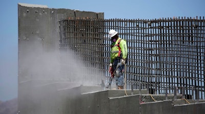 In this May 19, 2017, photo, a man works on the Southern Nevada portion of U.S. Interstate 11 near Boulder City, Nev. President Donald Trump is planning a major push next week to promote a $1 trillion rebuilding of the nation's roads and bridges as his agenda has struggled in Congress and been overshadowed by White House controversies.