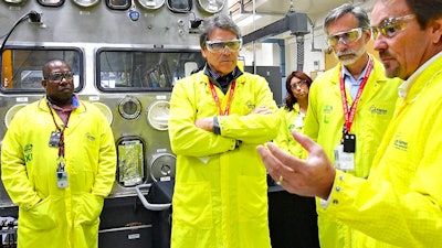 In this May 10, 2017, file photo, U.S. Secretary of Energy Rick Perry, second from left, accompanied by Laboratory Director Charlie McMillan, second from right, learns about capabilities at the Los Alamos National Laboratory's Plutonium Facility, from Jeff Yarbrough, right, Los Alamos Associate Director for Plutonium Science and Manufacturing in Los Alamos, N.M. Criticism of the safety record at one of the nation's top federal laboratories is intensifying as work at Los Alamos National Laboratory ramps up to produce a key component for the nation's nuclear weapons cache.