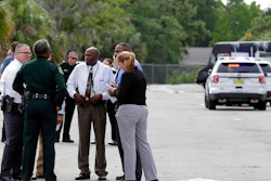 Authorities confer near the scene of a shooting where they said there were multiple fatalities in an industrial area near Orlando, Fla., Monday, June 5, 2017. The Orange County Sheriff's Office said on its official Twitter account that the situation has been contained.