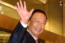 In this Sunday, Feb. 24, 2013, file photo, Foxconn Technology Group Chairman Terry Gou waves as he arrives at a hotel in Beijing. Gou says there is ‘still a chance’ the Taiwanese electronics giant might be able to buy Toshiba’s chip business despite the Japanese company’s choice of another bidder as its preferred buyer.